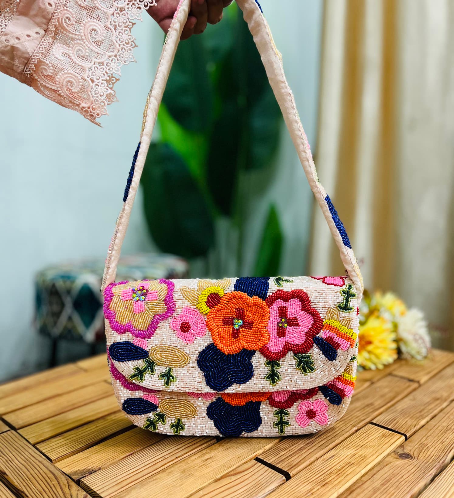 Colorful beaded shoulder bag with floral design, featuring yellow flowers, green leaves, and a multicolored background.