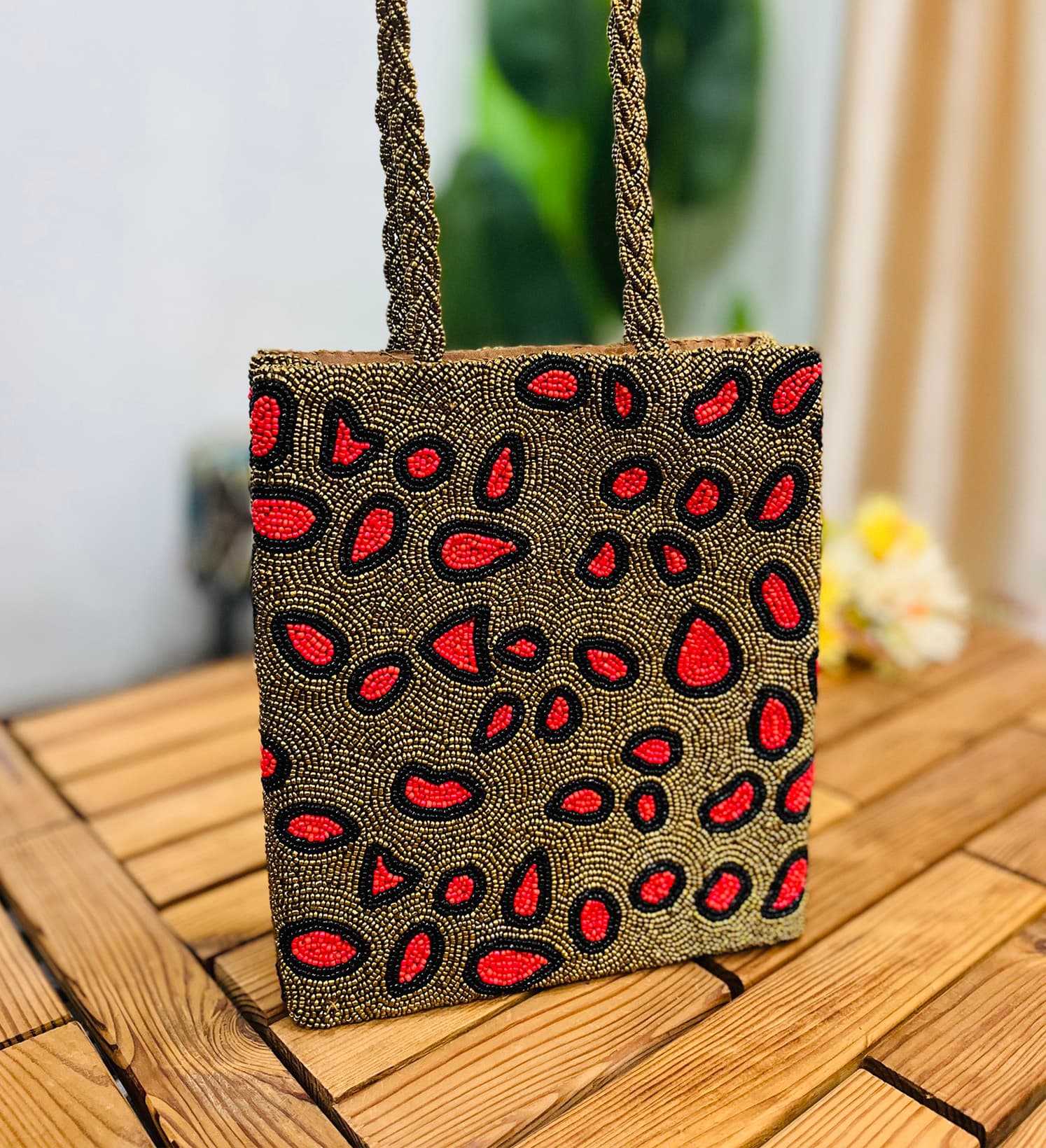 Leopard print tote bag with intricate artisan hand-beading detail, featuring handles and a structured shape, by Zara.