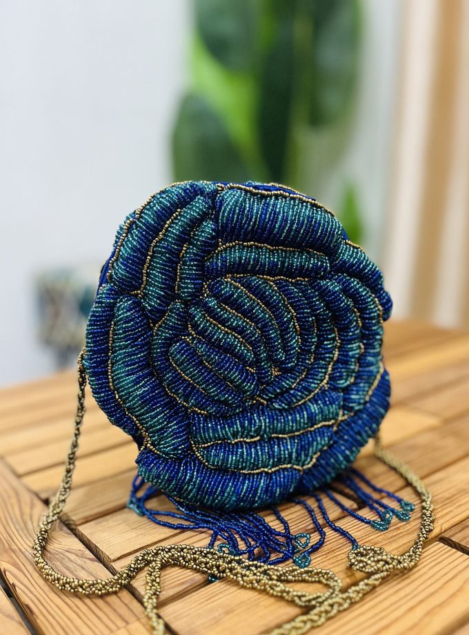 Colorful, intricately hand-beaded floral rosette clutch with vibrant patterns, showcasing artisanal craftsmanship by Zara
