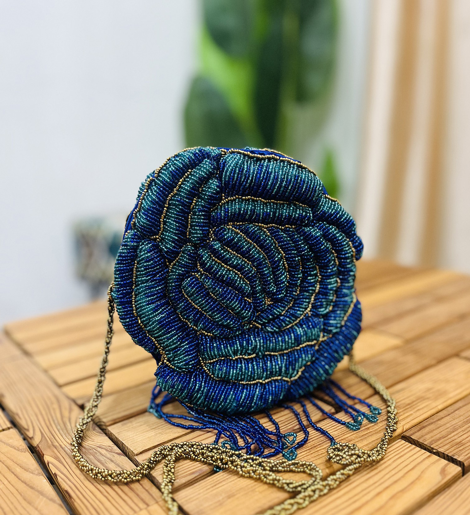 Colorful, intricately hand-beaded floral rosette clutch with vibrant patterns, showcasing artisanal craftsmanship by Zara