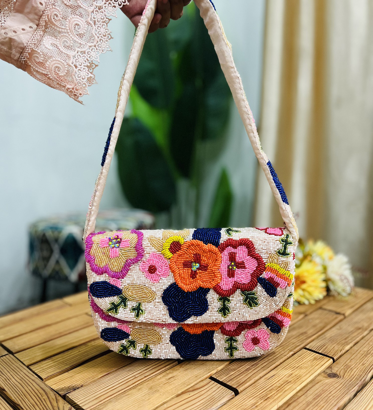 Colorful beaded shoulder bag with floral design, featuring yellow flowers, green leaves, and a multicolored background.