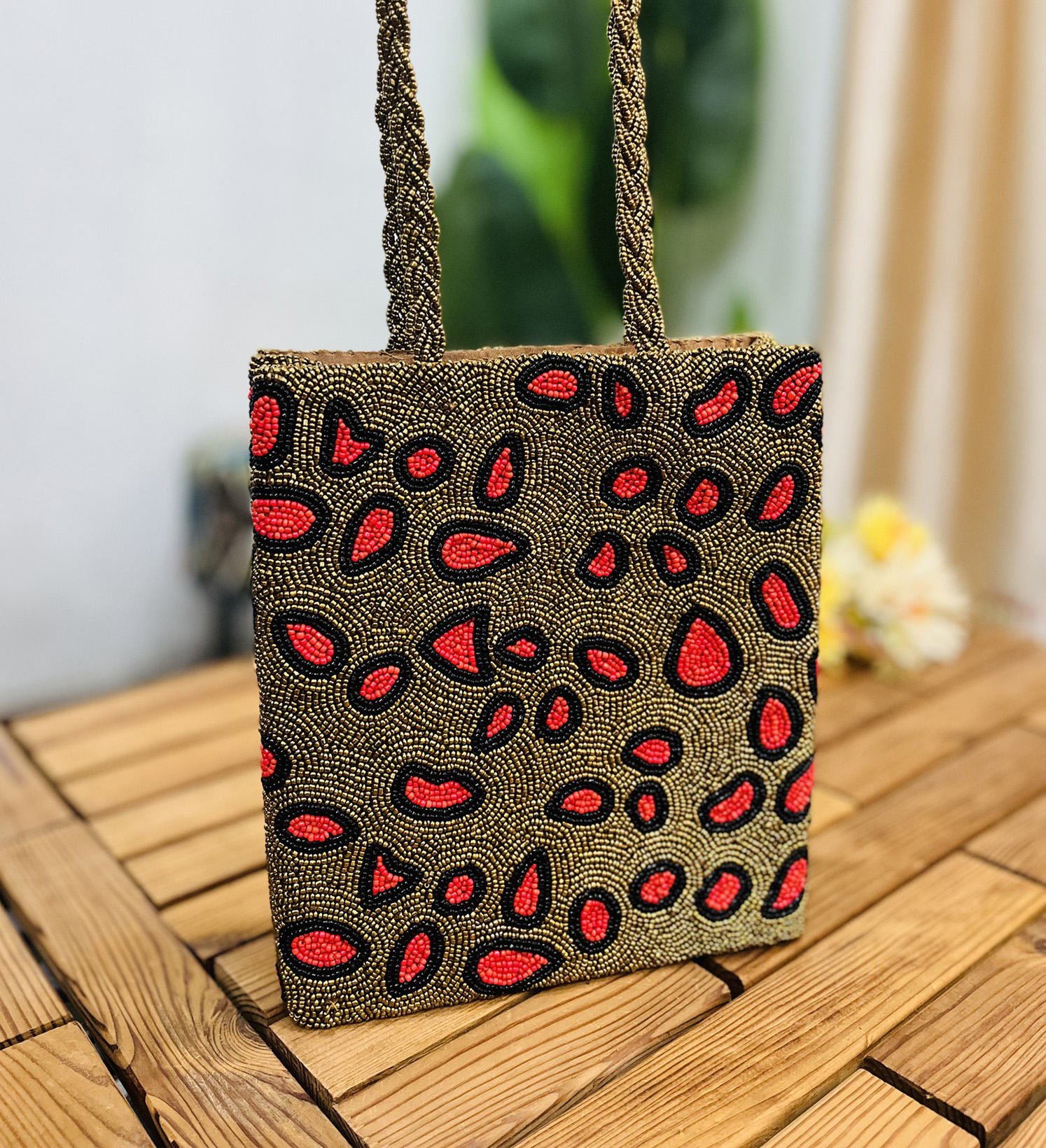 Leopard print tote bag with intricate artisan hand-beading detail, featuring handles and a structured shape, by Zara.
