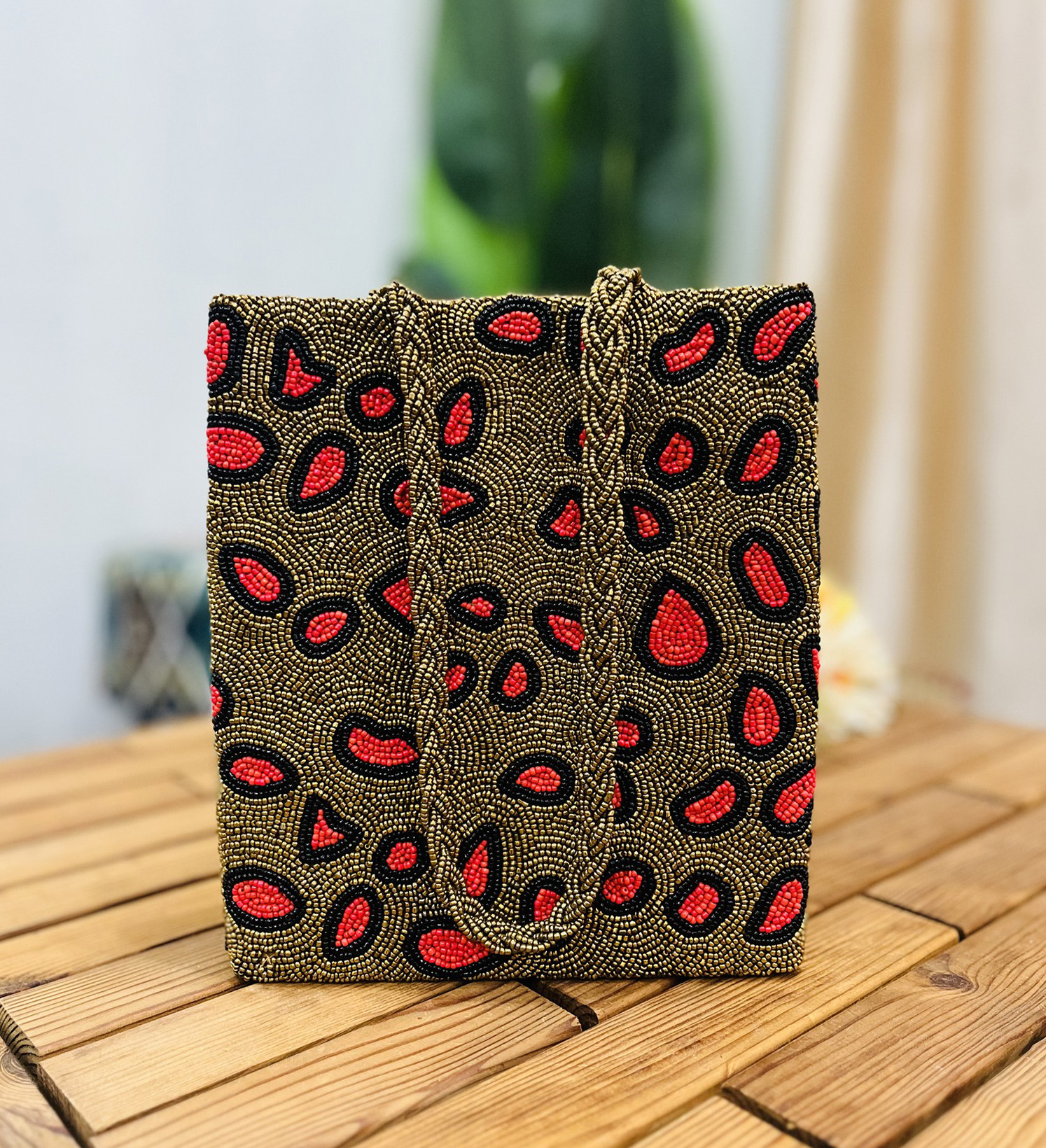 Leopard print tote bag with intricate hand-beaded detailing, featuring a mix of black, brown, and beige tones, crafted by