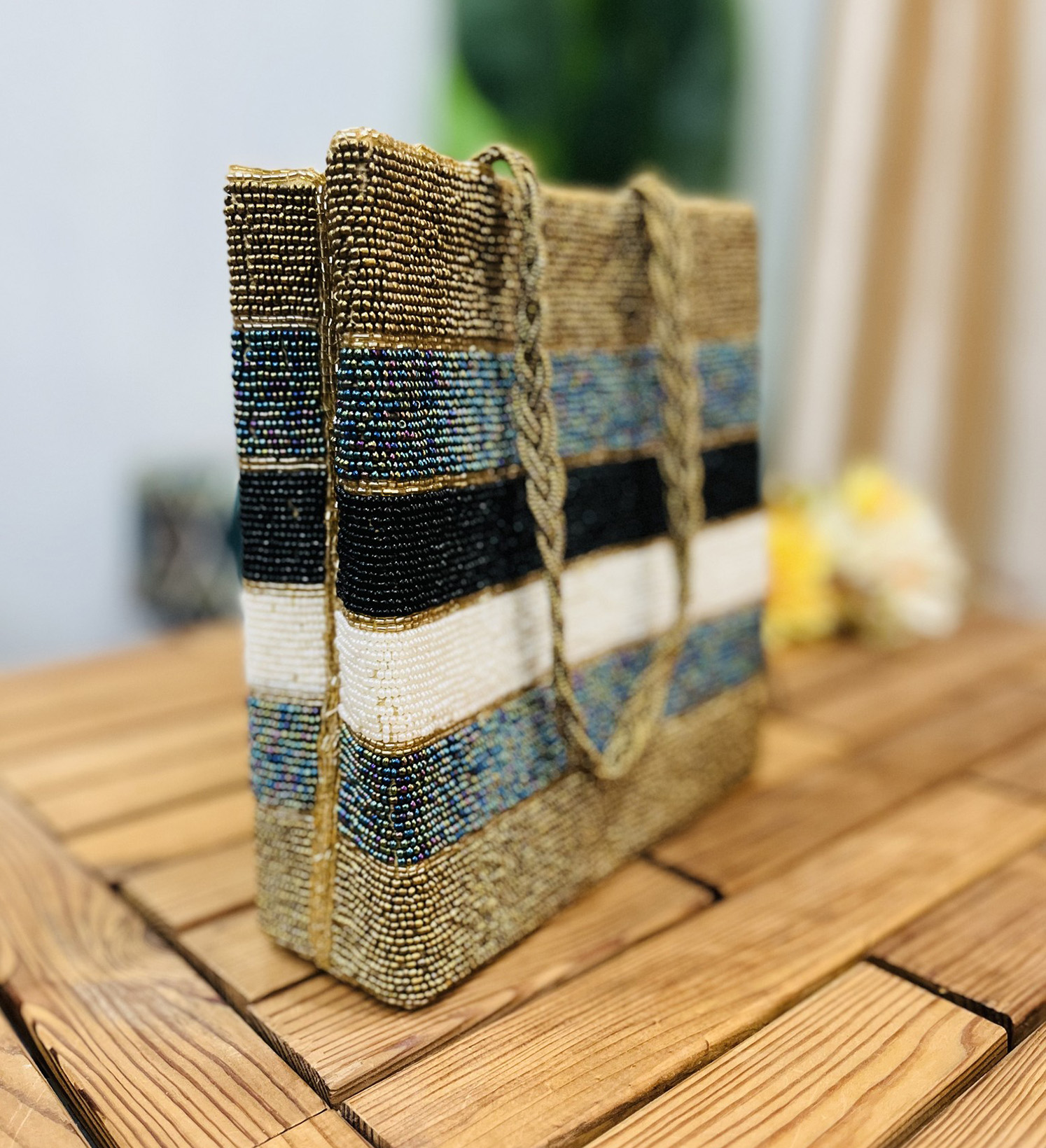 Metallic striped tote bag with intricate hand-beaded design, featuring a variety of colors and textures, from Zara Label.