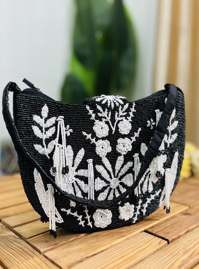 Monochrome floral patterned shoulder bag with intricate hand-beading; features a strap and branded by Zara.