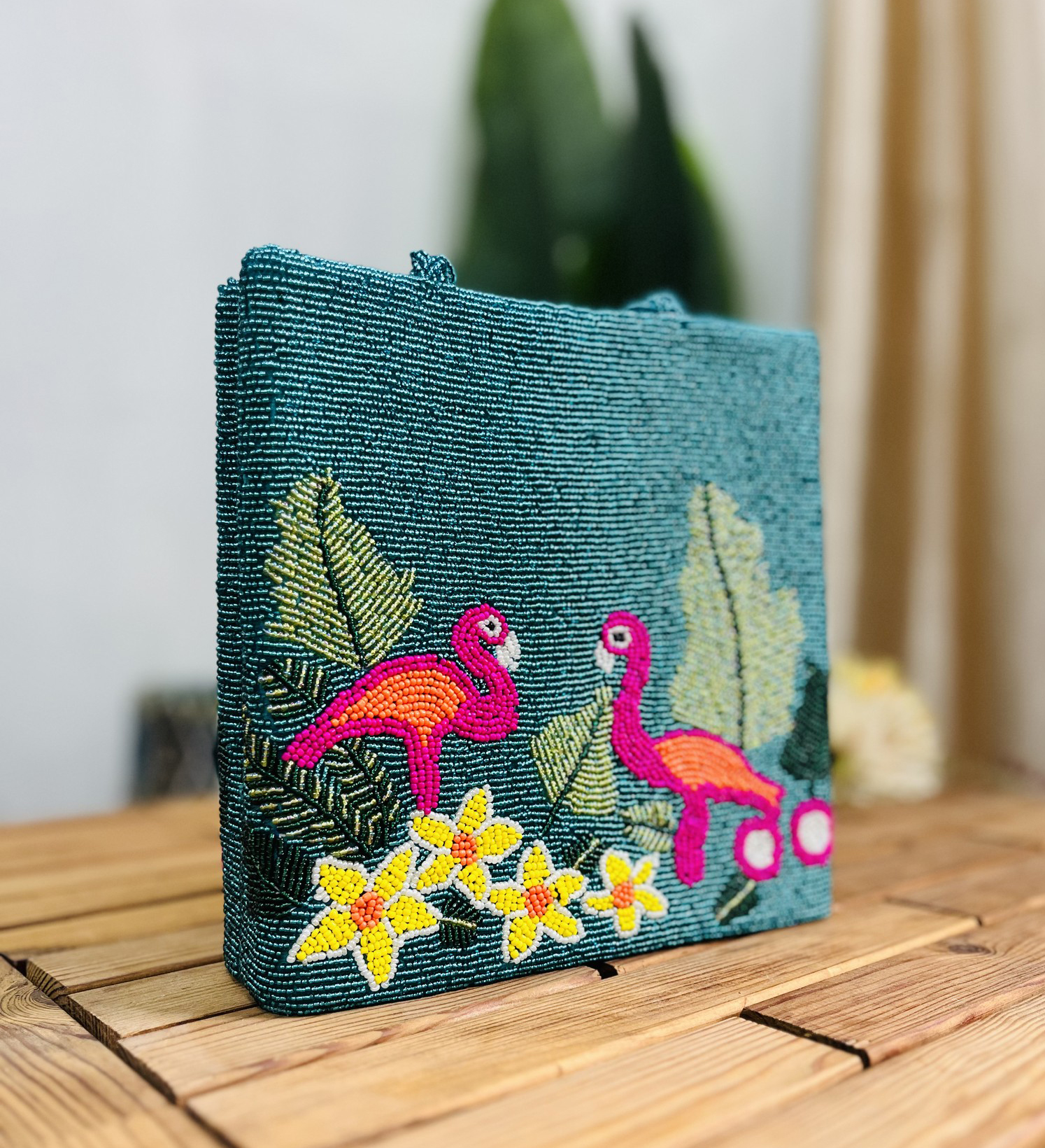 Colorful hand-beaded tote bag with flamingo pattern, featuring vibrant tropical leaves and flowers, by Zara Label.