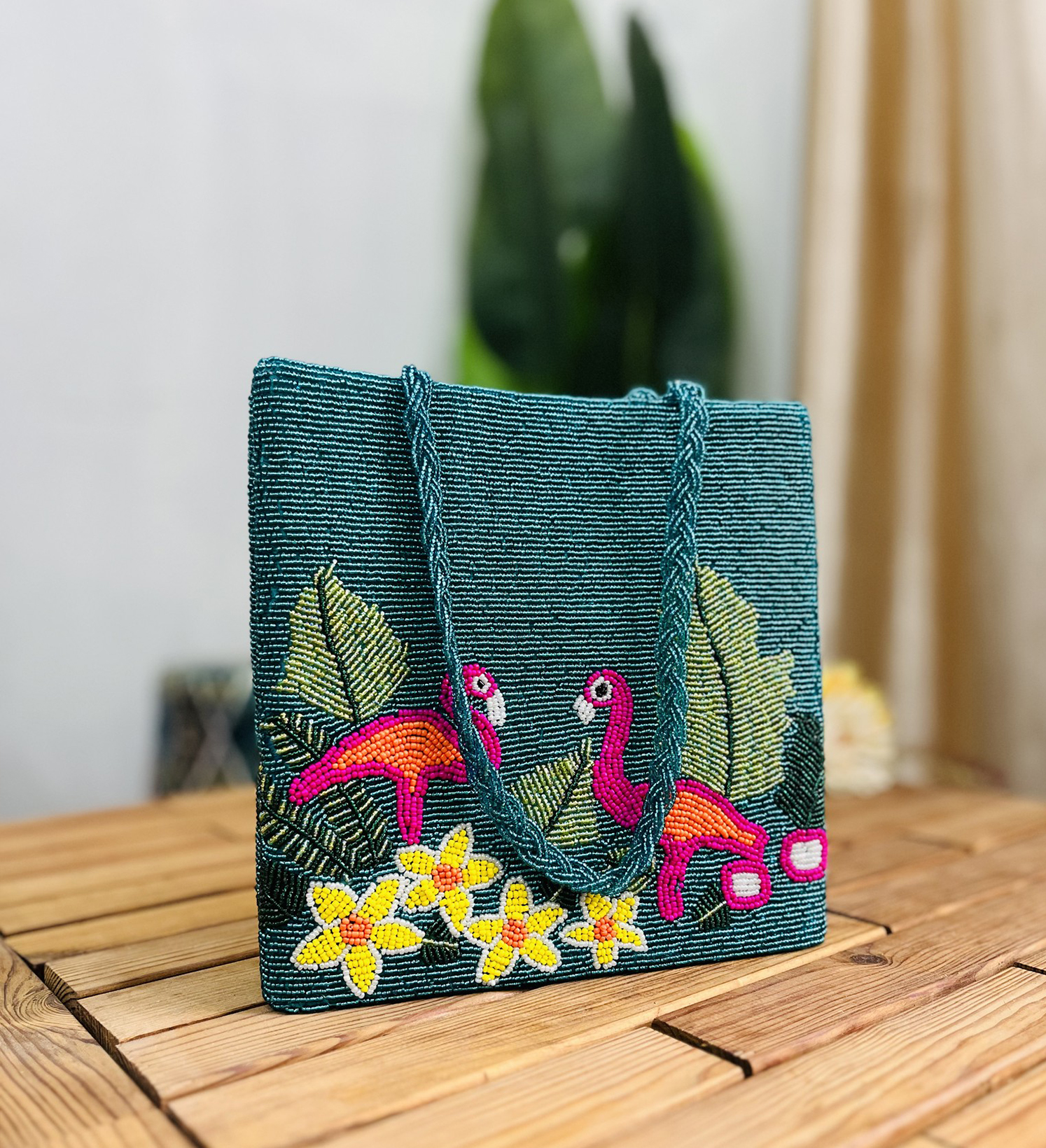 Hand-beaded tote bag with vibrant flamingo design, tropical patterns, and colorful beads against a light background.