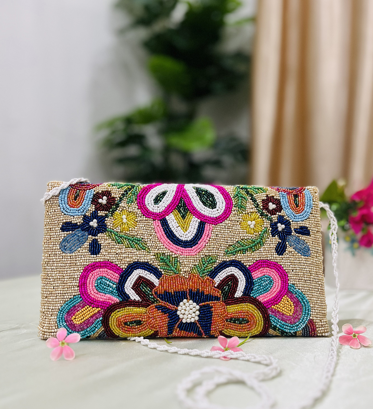 Colorful floral-themed beaded envelope clutch showcasing intricate beadwork by Zara, against a plain background.