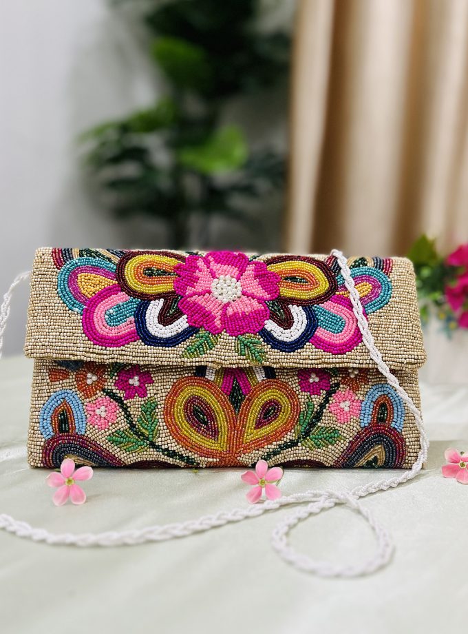 Hand-beaded envelope clutch with vibrant floral patterns, featuring intricate colorful beadwork by Zara Label on a black