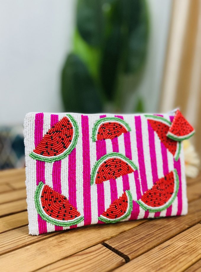 A vibrant hand-beaded pouch featuring a watermelon motif with green and red beads on a black background.