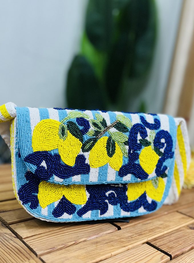 Small lemon-shaped shoulder bag with intricate hand-beaded details on a green strap, designed by Zara.